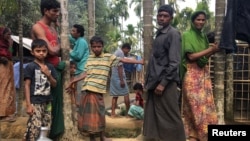 Rohingya Muslims gather outside their makeshift homes on land belonging to Bangladeshi farmer Jorina Katun near Kutapalong refugee camp in the Cox's Bazar district of Bangladesh, Feb. 9, 2018.