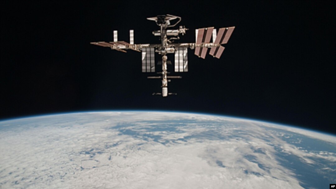 This May 23, 2011 photo released by NASA shows the International Space Station above the Earth, taken by Expedition 27 crew member Paolo Nespoli from the Soyuz TMA-20 following its undocking.
