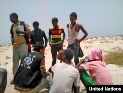 FILE - U.N. Migration Agency staff assist Somali and Ethiopian migrants who were forced into the sea by smugglers.