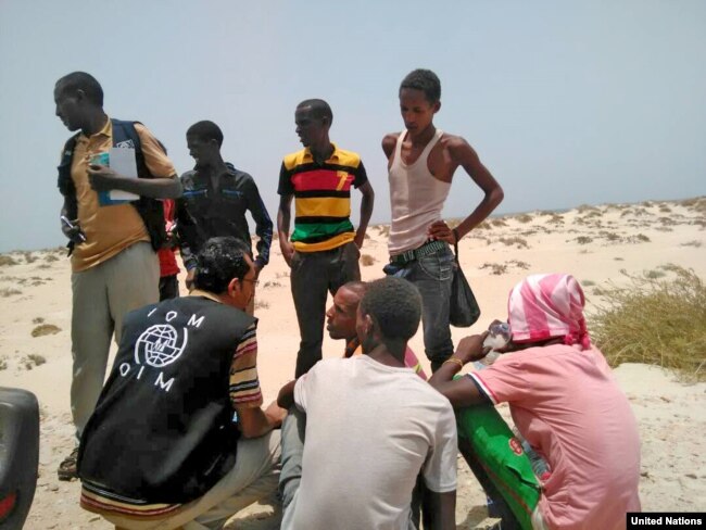 FILE - U.N. Migration Agency staff assist Somali and Ethiopian migrants who were forced into the sea by smugglers.