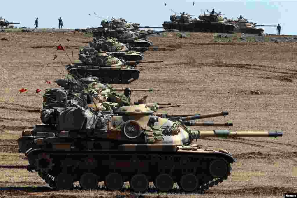 Turkish army tanks take up position on the Turkish-Syrian border near Suruc, Oct. 6, 2014.