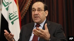 Iraq's Prime Minister Nouri al-Maliki speaks during an interview with The Associated Press in Baghdad, Iraq, Saturday, December 3, 2011.