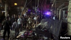 Residents inspect a damaged area caused by two explosions in Beirut's southern suburbs, Lebanon, Nov. 12, 2015. 