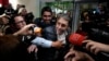 Media swarm Fabio Ochoa, center, a former member of Cartel of Medellin, upon his arrival at El Dorado airport, after being deported from the United States, in Bogota, Colombia, Dec. 23, 2024. 