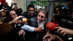 Media swarm Fabio Ochoa, center, a former member of Cartel of Medellin, upon his arrival at El Dorado airport, after being deported from the United States, in Bogota, Colombia, Dec. 23, 2024. 