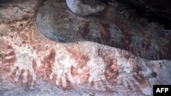 FILE - An undated photo of some of the prehistoric long handprints stencils frieze discovered in Gua Terusan in Kalimantan, Borneo in 2001.