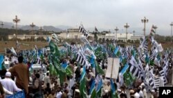 Supporters of religious parties rally against government allowing NATO to resume shipping supplies through the country to its troops in neighboring Afghanistan, near the Parliament in Islamabad, Pakistan, March 27, 2011.