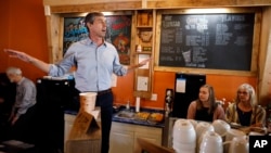 FILE - Democratic presidential candidate Beto O'Rourke speaks to local residents during a stop at the Central Park Coffee Company in Mount Pleasant, Iowa, March 15, 2019. 