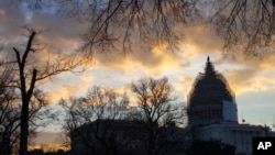 The sun rises over the U.S. Capitol in Washington, Jan. 5, 2015, as the 114th Congress prepares to open Tuesday. (AP Photo/J. Scott Applewhite) 