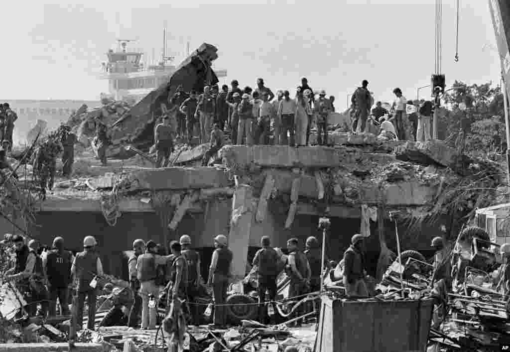 FILE - Rescuers continue to probe the wreckage of the U.S. Marine barracks after a suicide truck bomb near Beirut airport, Lebanon, Oct. 23, 1983.