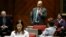 Arizona Rep. Michelle Ugenti-Rita, foreground, and others listen to Rep. Don Shooter, center background, as he reads a statement regarding sexual harassment and other misconduct complaints made against him by Ugenti-Rita and others, on the House floor at the Capitol, Jan. 9, 2018, in Phoenix, Arizona.