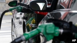 FILE - Gas is pumped into vehicles at a BP gas station in Hoboken, New Jersey, June 30, 2016. 