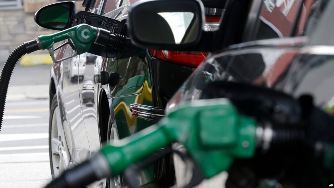FILE - Gas is pumped into vehicles at a BP gas station in Hoboken, New Jersey, June 30, 2016. 
