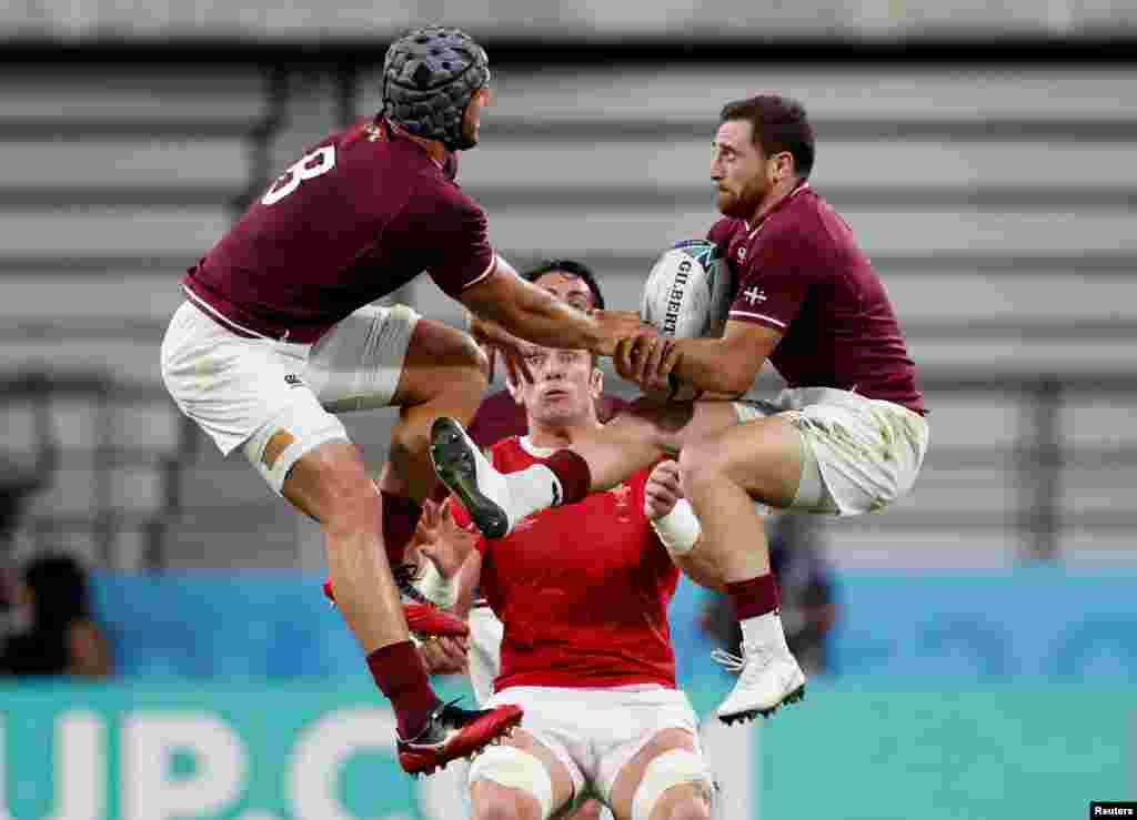 Wales&#39; Alun Wyn Jones and Georgia&#39;s Beka Gorgadze and Vasil Lobzhanidze jump for the ball during the Japan 2019 Rugby World Cup Pool D match between Wales and Georgia at the City of Toyota Stadium in Toyota.