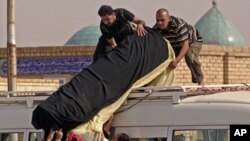 کفنی قوربانیـیه‌کی توندوتیژیـیه‌کانی ناو عێراق، (ئه‌رشیفی وێنه‌)