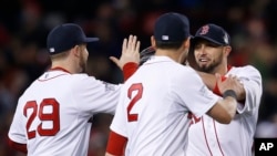 Boston Red Sox's Daniel Nava (29), Jacoby Ellsbury (2) and Shane Victorino celebrate after the Red Sox defeated the St. Louis Cardinals, 8-1, in Game 1 of baseball's World Series, Oct. 23, 2013.