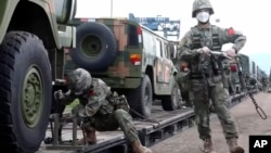 In this handout photo taken from video released by Russian Defense Ministry Press Service on Aug. 29, 2022, Chinese soldiers arrive at Grodekovo railway station to participate in war games drills in Grodekovo, Russia. (Russian Defense Ministry Press Service via AP)