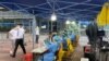Medical workers in protective suits collect swabs at a nucleic acid testing site at the Software Park in Nanshan district, following the coronavirus disease (COVID-19) outbreak in Shenzhen, Guangdong province, China, Sept. 2, 2022. 