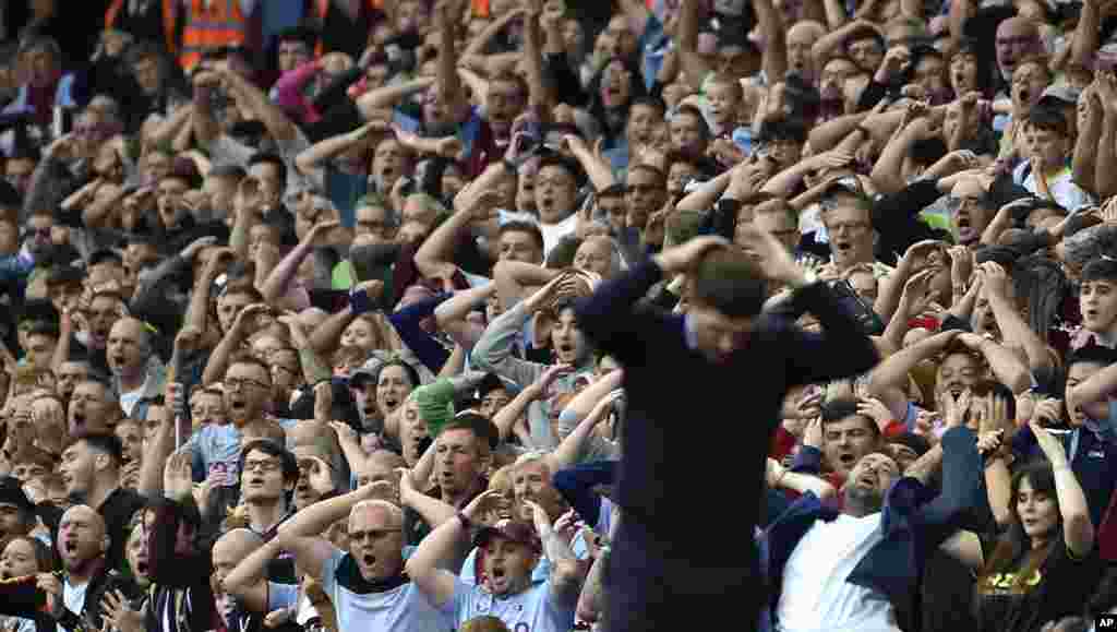 Fans react during the English Premier League soccer match between Aston Villa and Manchester City at Villa Park in Birmingham, England, Sept. 3, 2022