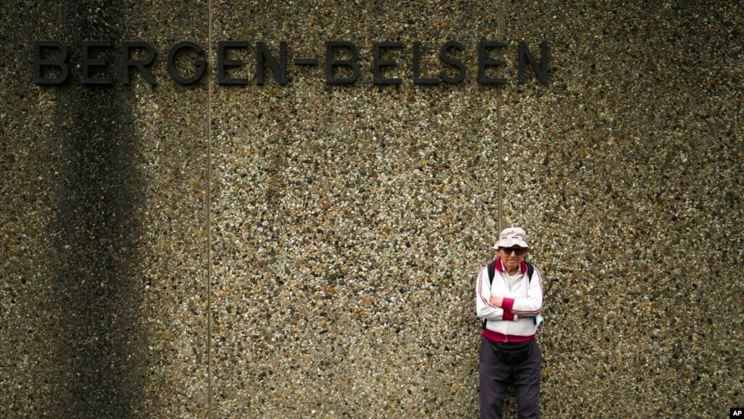 Israeli Olympic race walker Shaul Ladany poses for a photo at the entrance of the Nazi concentration camp Bergen-Belsen in Bergen, Germany, Sept. 3, 2022. 