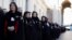 FILE - Members of the Order of the Knights of Malta arrive in St. Peter's Basilica for their 900th anniversary at the Vatican, Feb. 9, 2013. 