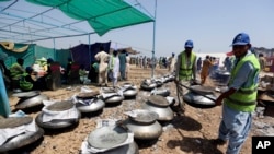 FILE - Pakistani cooks prepare food for flooding victims, organized by the Alkhidmat Foundation in Jaffarabad, Pakistan, Sept. 5, 2022.