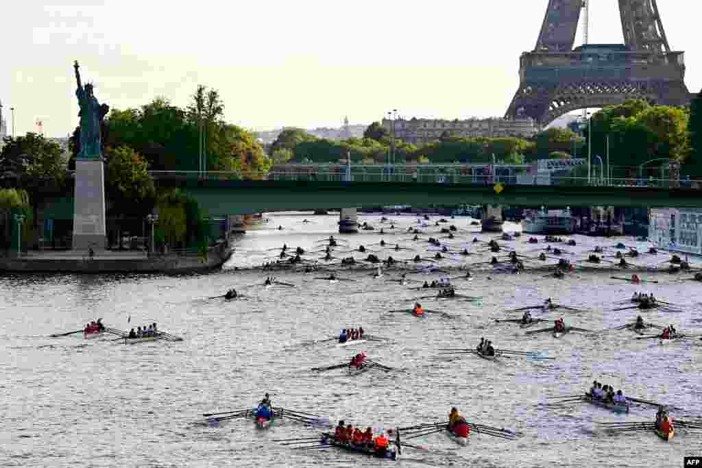 Nearly 1000 rowers, in some 230 boats, scull towards the Eiffel Tower as they participate in the 37th edition of &#39;La Traversee de Paris en Aviron&#39; along the River Seine, which flows through the center of Paris, France.