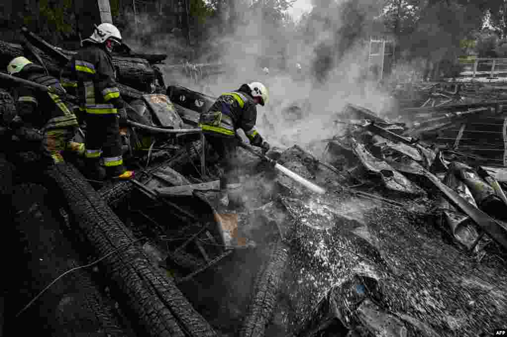 Firefighters douse the rubble of a restaurant complex destroyed by a missile strike in the second largest Ukrainian city of Kharkiv, amid the Russian invasion of Ukraine.