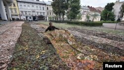 Ukrainians make camouflage nets and plan to create more that 2,000 square meters of camouflage nets for Ukrainian army during weekends in Lviv, Sept. 4, 2022. 