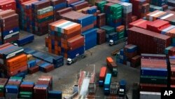 Trucks transport cargo at a container terminal in the port of Dalian, China. (file)