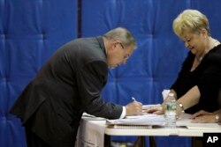 U.S. Sen. Bob Menendez checks in before casting his vote in the New Jersey primary election, June 5, 2018.