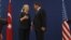 U.S. Secretary of State Hillary Clinton and Turkish Foreign Minister Ahmet Davutoglu talk after their news conference in Istanbul, Turkey, August 11, 2012.