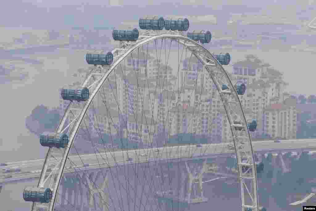 The Singapore Flyer observation wheel is shrouded by haze in Singapore. 