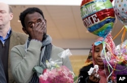 Isahaq Ahmed Rabi, left, wipes his face as he stands with his wife during a news conference shortly after Rabi's arrival at Seattle Tacoma International Airport, in SeaTac, Washington, Feb. 6, 2017. Rabi was blocked from entry to the U.S. last week due to President Donald Trump's immigration order. Rabi is a citizen of Somalia. His wife is a U.S. citizen.