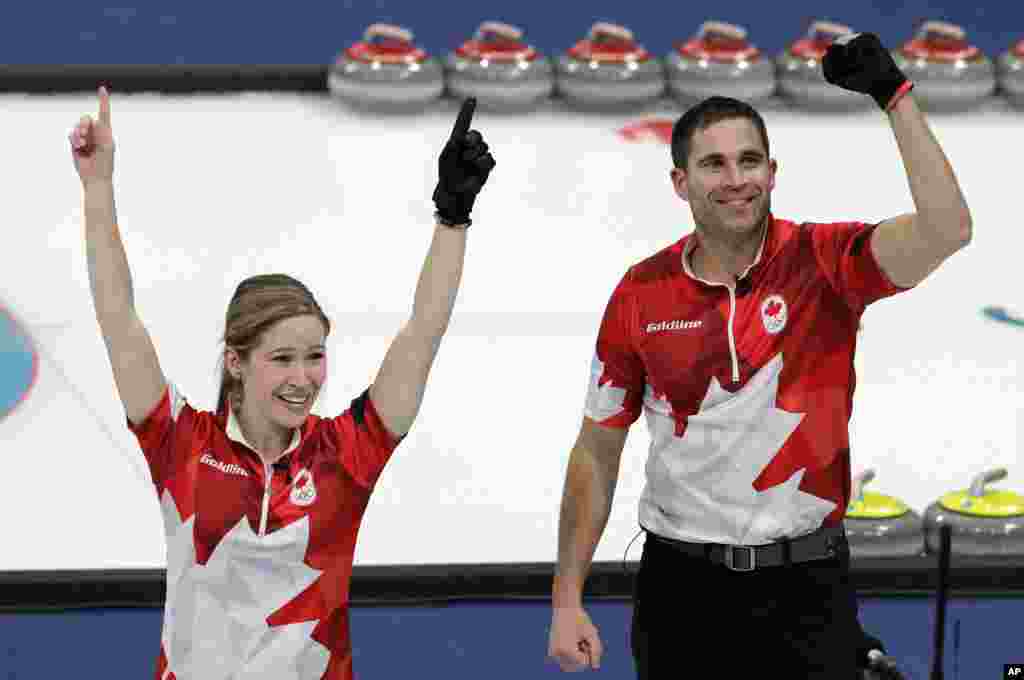 Canada's Kaitlyn Lawes, left, and John Morris jubilate after winning their mixed doubles curling finals match against Switzerland at the 2018 Winter Olympics in Gangneung, South Korea, Feb. 13, 2018. Canada won the gold medal.