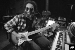Jerry Garcia, leader of the legendary group,The Grateful Dead, works with his guitar, May 8, 1979.