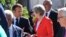 FILE - French President Emmanuel Macron (L) talks with British Prime Minister Theresa May when arriving for a family photo at the informal EU summit in Salzburg, Austria, Sept. 20, 2018. 