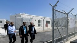 Greek Migration Minister Notis Mitarachi inspects a newly inaugurated closed-type migrant camp on the island of Samos, Greece, Sept. 18, 2021.