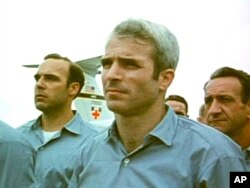 FILE - An image from video obtained exclusively by Associated Press Television News shows then-prisoner of war John McCain, standing with other POWs as they were released by the North Vietnamese in Hanoi on March 14, 1973.