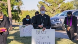 Bishop Mark Seitz, center, kneels with other demonstrators at Memorial Park holding a Black Lives Matter sign in El Paso, Texas, June 1, 2020 (Catholic Diocese of El Paso)