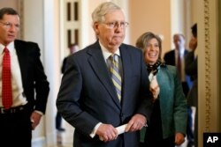 In this Oct. 29, 2019, photo, Senate Majority Leader Mitch McConnell of Ky., walks to the podium Oct. 29, 2019, on Capitol Hill in Washington.