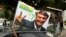 A supporter of Brazil's new president-elect, Jair Bolsonaro, celebrates in front of Bolsonaro's condominium at Barra da Tijuca neighborhood in Rio de Janeiro, Brazil, Oct. 29, 2018. 