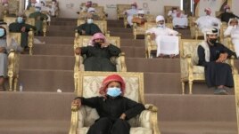 Emirati camel breeder families watch as the competition winners are decided at Al Dhafra Festival in Liwa desert area 120 kilometres southwest of Abu Dhabi, United Arab Emirates, Wednesday, Dec. 22, 2021. (AP Photo/Isabel DeBre)