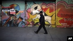 A man walks by a commercial area of closed shops during a government-ordered lockdown to curb the spread of the new coronavirus in Buenos Aires, Argentina, June 26, 2020.