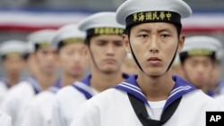 Taiwan Navy sailors stand in attention during the commissioning ceremony of two U.S.-made Kidd class destroyers, Thursday, Nov. 2, 2006, at the naval harbor or Suao, northeast Taiwan. 