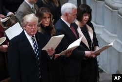 From left, President Donald Trump, first lady Melania Trump, Vice President Mike Pence and his wife Karen, sing together during a National Prayer Service at the National Cathedral, in Washington, Jan. 21, 2017.