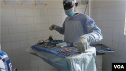 Dr. Tebeu prepares his instruments for the operation, Yaounde, Cameroon, June, 2014. (Moki Edwin Kindzeka/VOA)