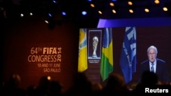 FIFA President Sepp Blatter is seen in a big screen as he delivers a speech during the opening ceremony of the 65th FIFA Congress in Sao Paulo, June 11, 2014.