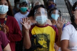 A devotee offers prayers outside the Quiapo church on Good Friday, April 2, 2021, as the government implements a strict lockdown to prevent the spread of the coronavirus in Manila.