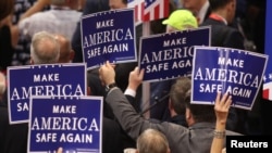 Delegates hold signs during speeches at the Republican National Convention, Cleveland, Ohio, July 18, 2016. 